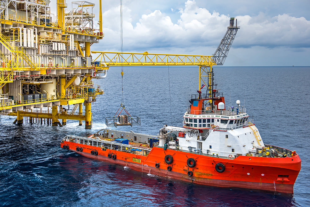 Platform Supply Vessel - supply vessel unloading cargo to oil rig